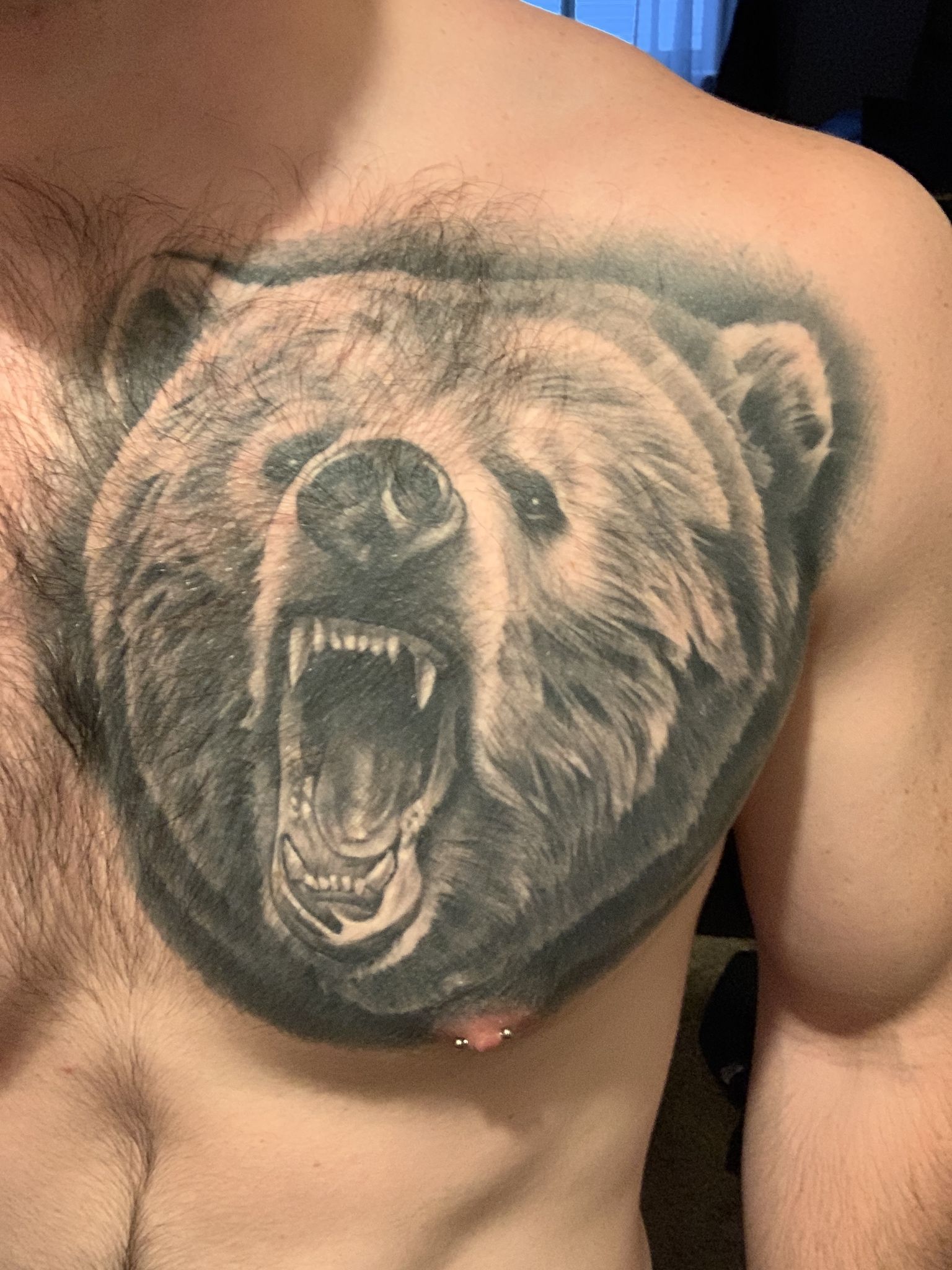 A Man S Chest With An Angry Bear Tattoo On His Chest And The Upper Part