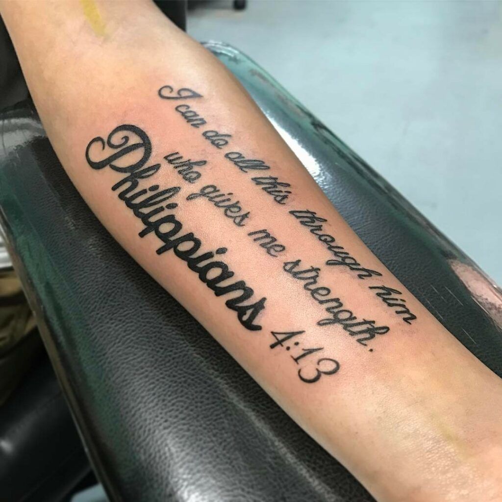 Male With Tattoo Of Philippians 4 13 Bible Verse On Outer Forearm