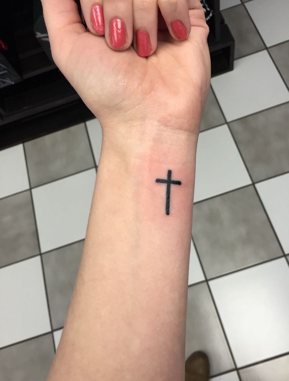 Minimalist Cross Tattoo On The Wrist