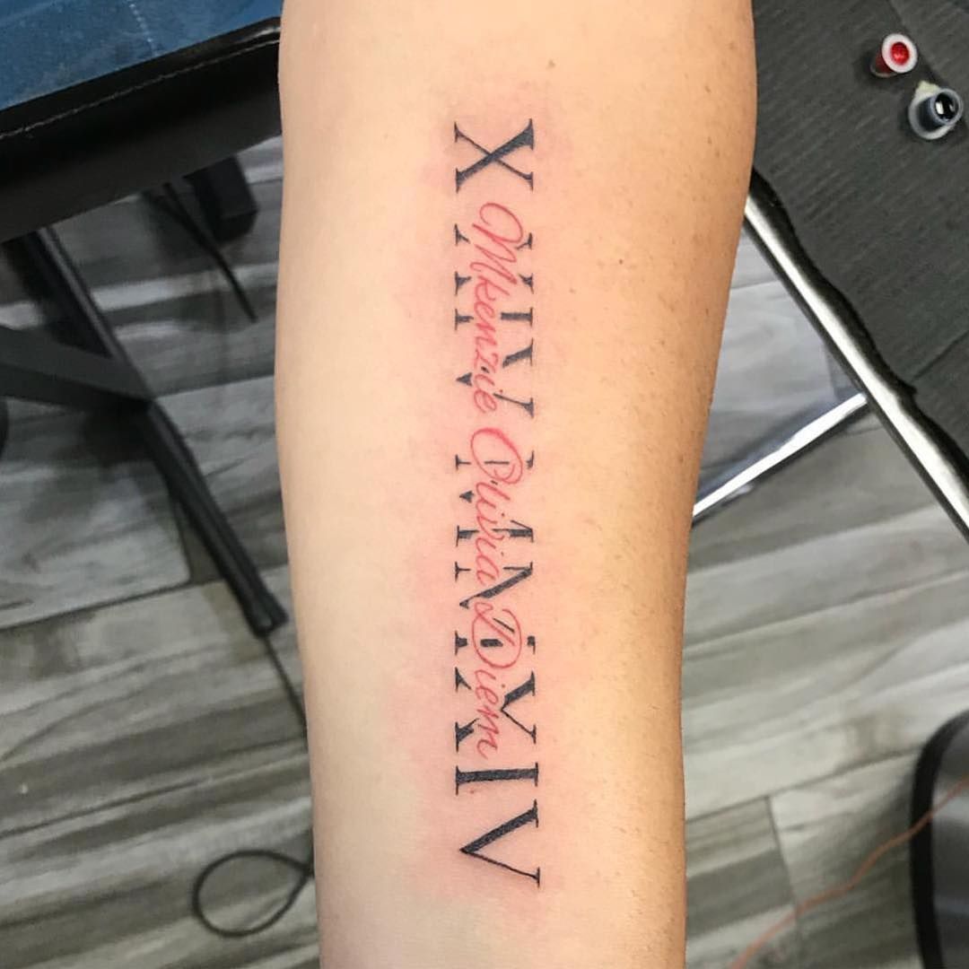 Roman Numeral Tattoo Located On The Upper Arm