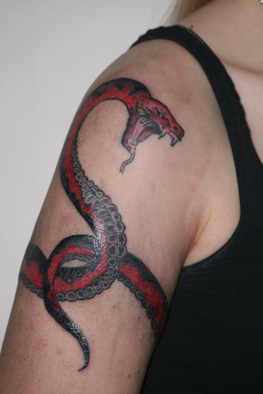 Snake Wrapped Around Arm Tattoo: Meaning and Designs